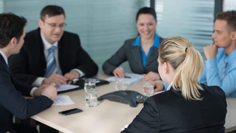 Group of lawyers in a meeting, sitting around a conference table.