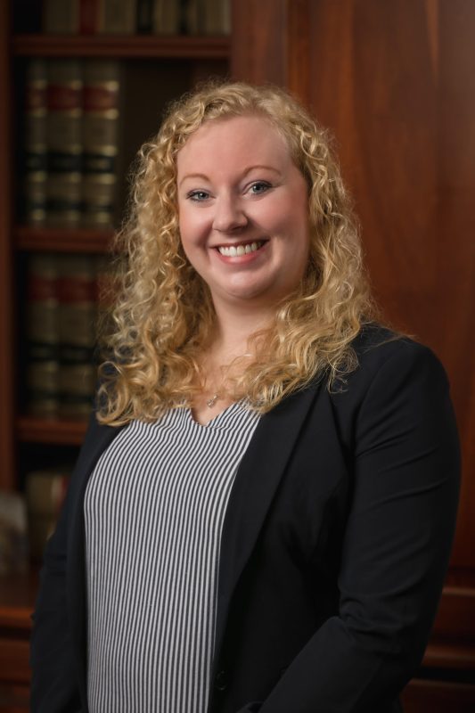 A photo of Allison Santer standing in her office